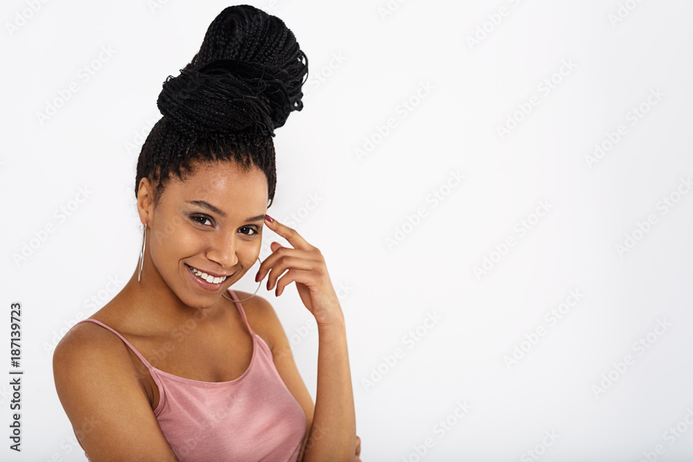 Young smiling woman with finger near head, looking at camera Young smiling woman with finger near head, looking at camera