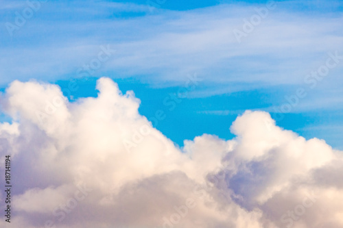 Fluffy clouds against a bright blue sky  background 
