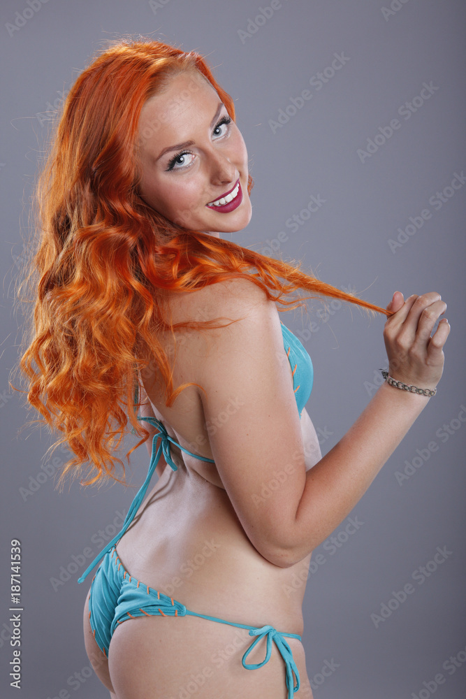 Bright redhead in turquoise bikini Stock Photo | Adobe Stock