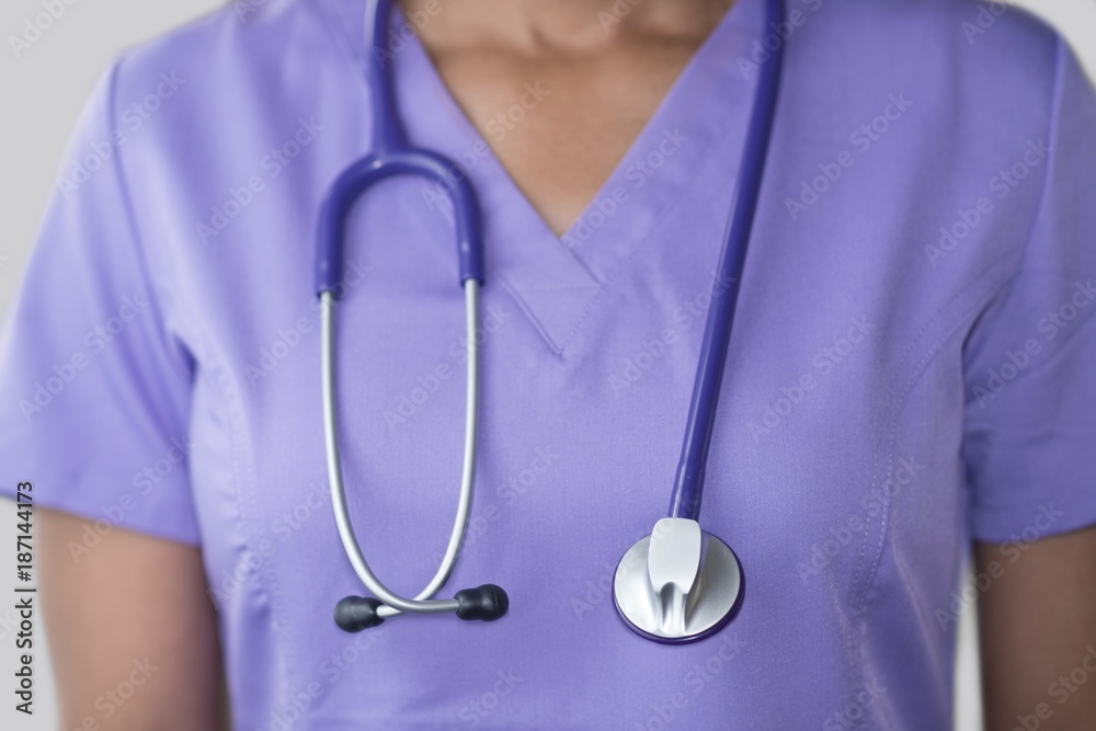 Female doctor in purple top with stethoscope Female doctor in purple top with stethoscope