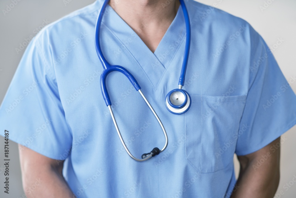 Male doctor in blue uniform with stethoscope Male doctor in blue uniform with stethoscope