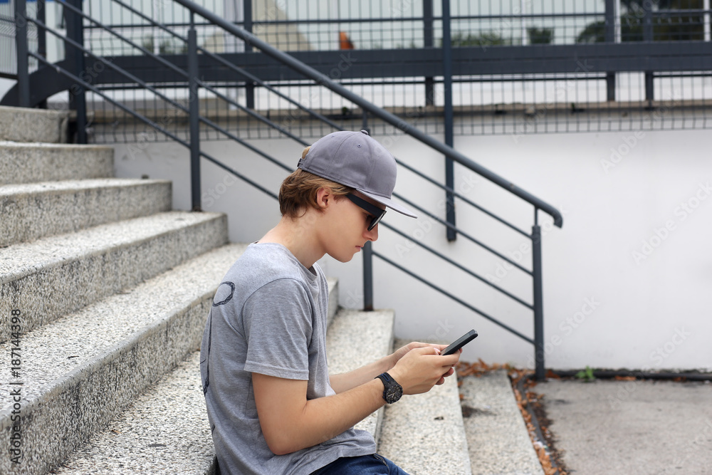 Teenage boy typing text message.Using smart phone. Teenage boy typing text message.Using smart phone.