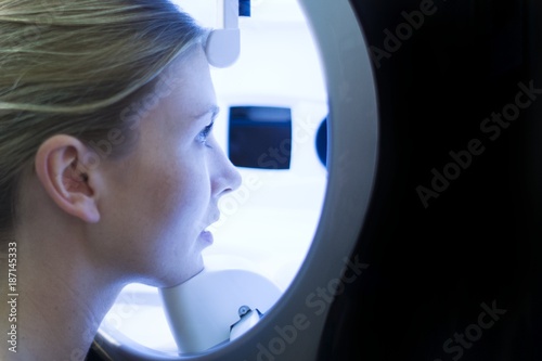 Young woman undergoing examination in skin clinic photo