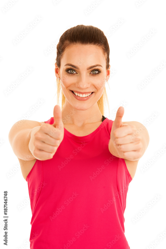 Beautifil young sporty woman shows thumb up as a gesture fo success isolated over white background Beautifil young sporty woman shows thumb up as a gesture fo success isolated over white background