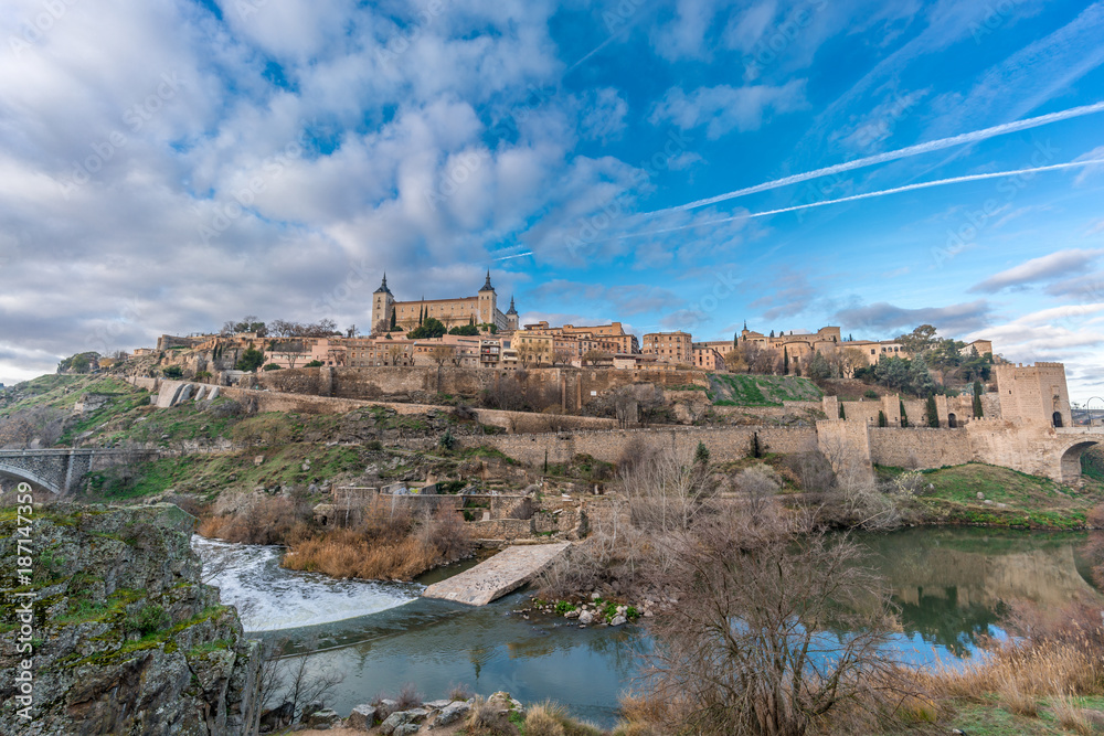 Toledo cityscape, Alcazar and Alcantara gate over the (Tajo) tagus river. UNESCO world heritage site.