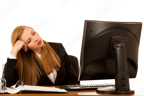 Beautiful youn g business woman yawning on work in office - exaustion on work photo