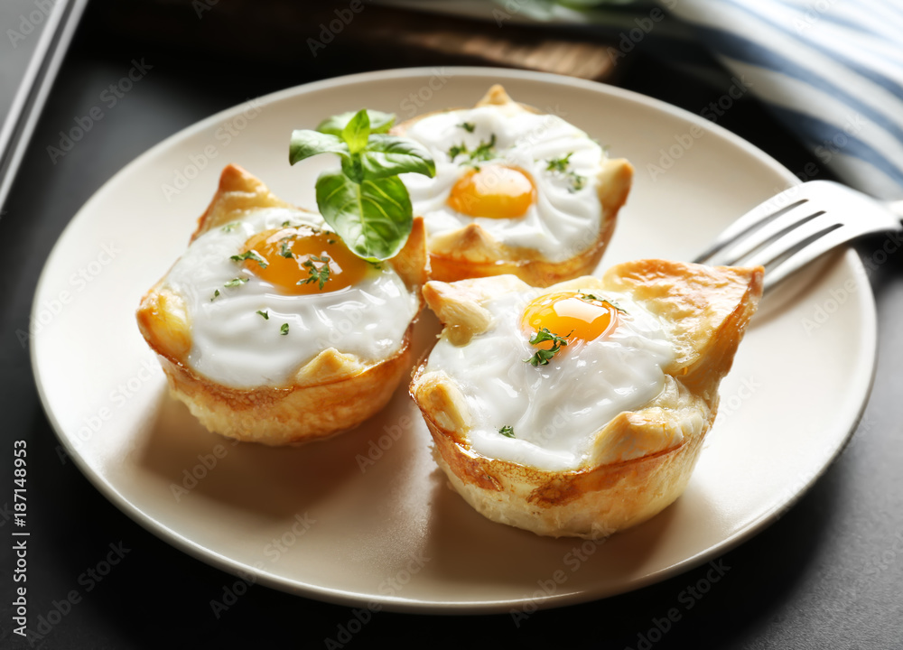 Tasty baked eggs in dough on plate Tasty baked eggs in dough on plate