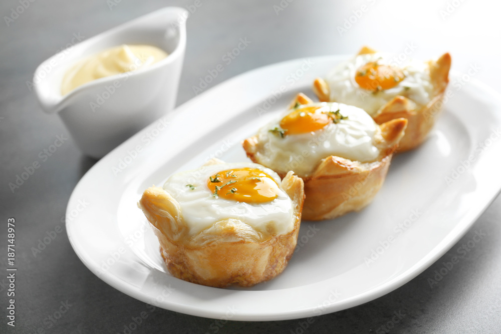 Tasty baked eggs in dough on plate Tasty baked eggs in dough on plate