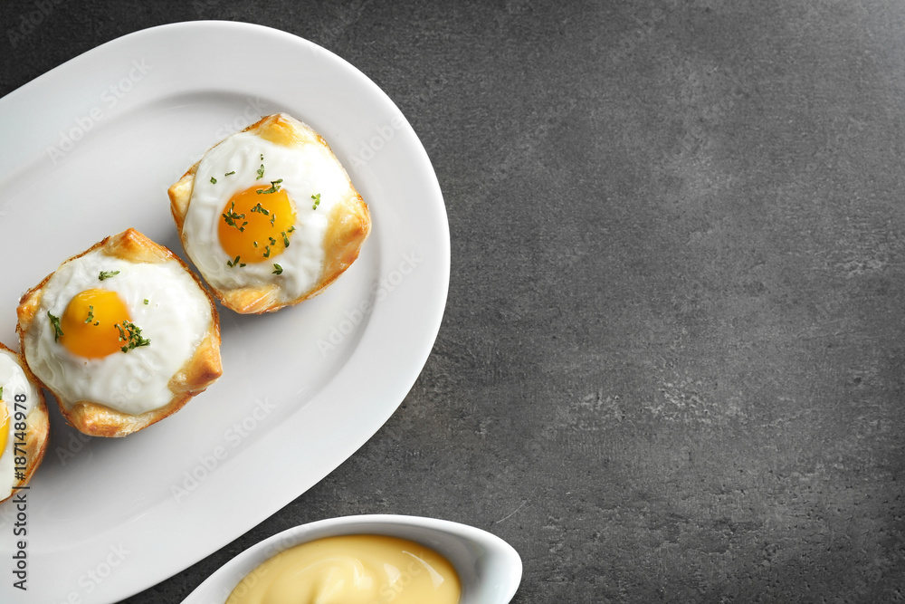 Tasty baked eggs in dough on plate Tasty baked eggs in dough on plate
