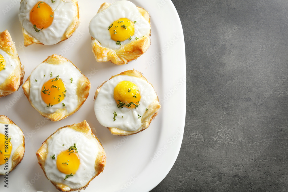Tasty baked eggs in dough on plate Tasty baked eggs in dough on plate