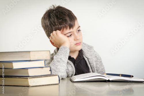 Stampa su tela Studio portrait of young boy struggling with his homework - learning difficultie