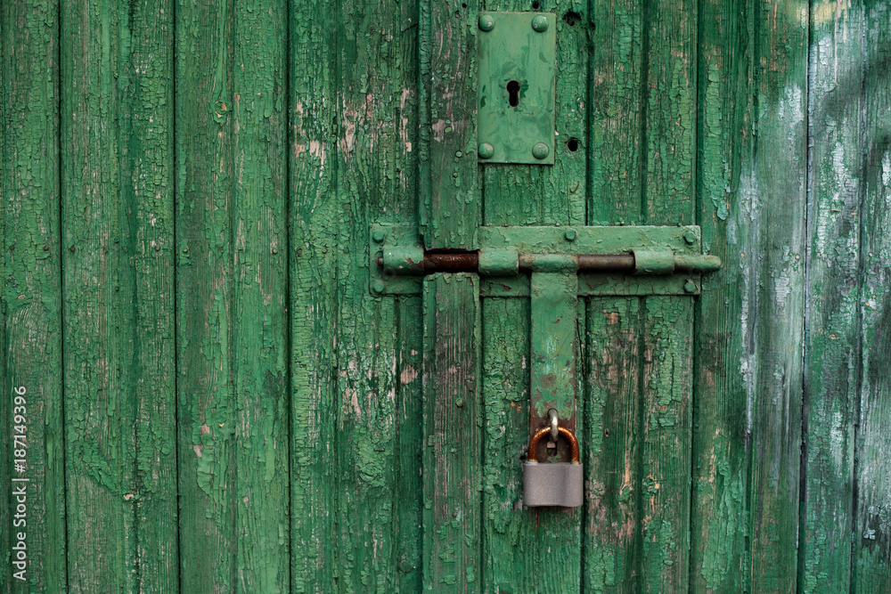 Old green wooden texture background with an old lock. Vertical wood planks Old green wooden texture background with an old lock. Vertical wood planks