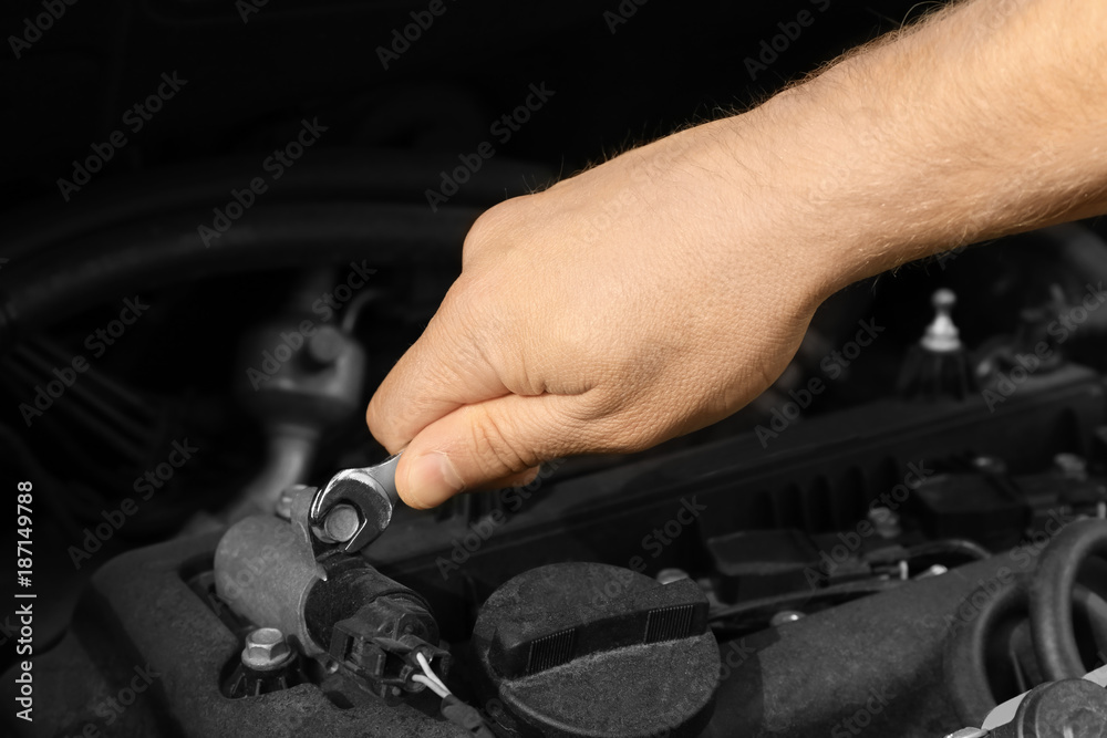 Auto mechanic repairing car, closeup