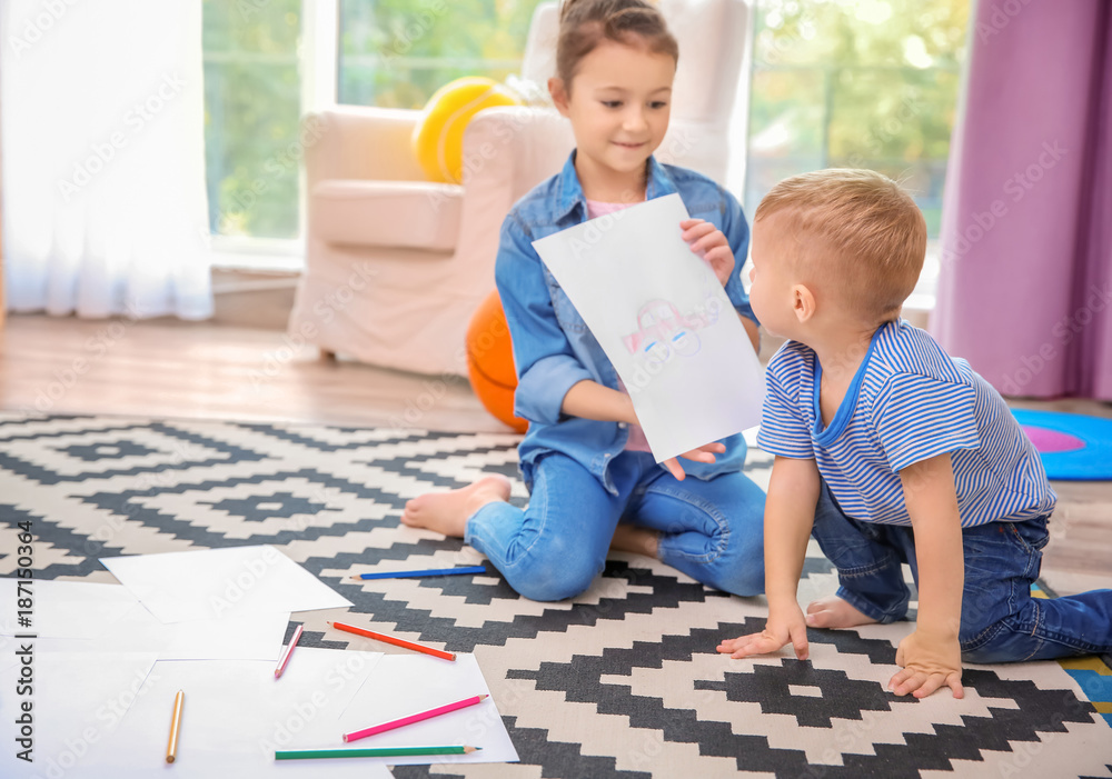 Little boy and girl with picture at home Little boy and girl with picture at home