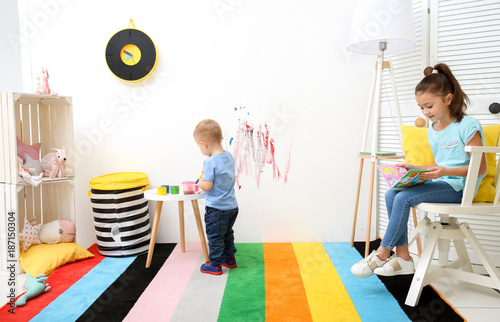 Little boy drawing and girl...