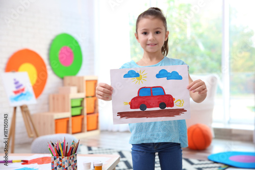 Little girl holding picture...