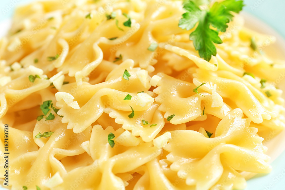 Delicious pasta with garlic and parsley on plate, closeup