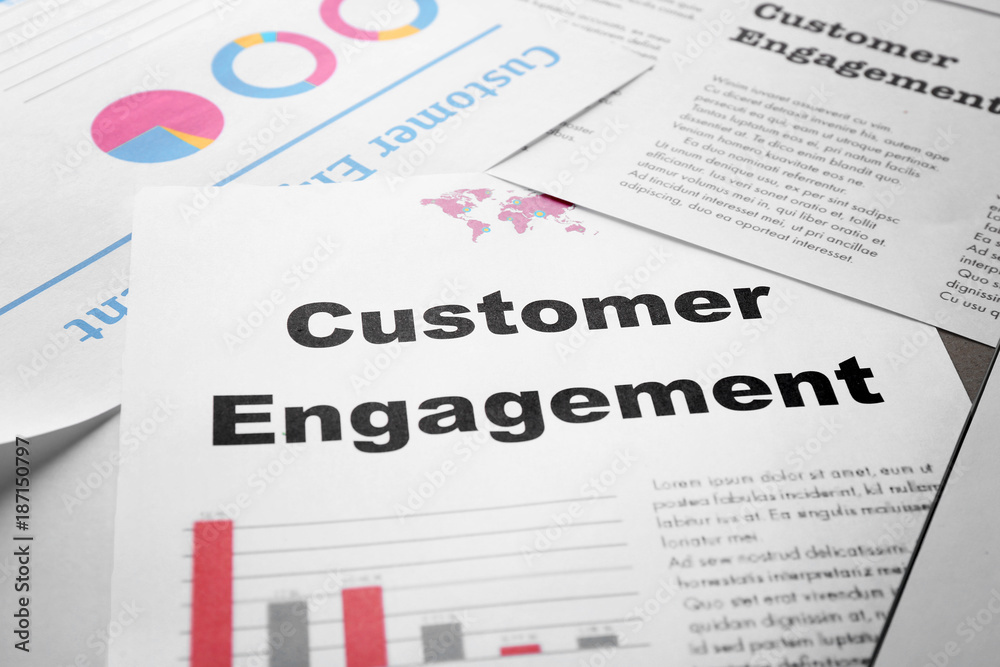 Sheet of paper with text CUSTOMER ENGAGEMENT on table Sheet of paper with text CUSTOMER ENGAGEMENT on table