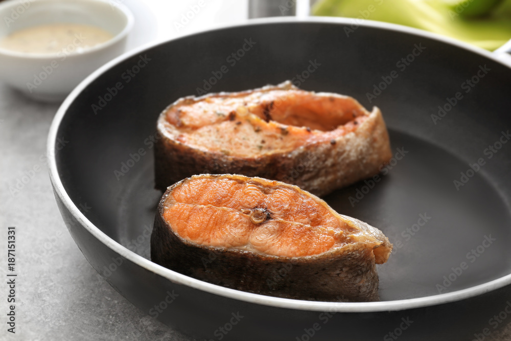 Tasty rainbow trout steaks on frying pan, closeup Tasty rainbow trout steaks on frying pan, closeup
