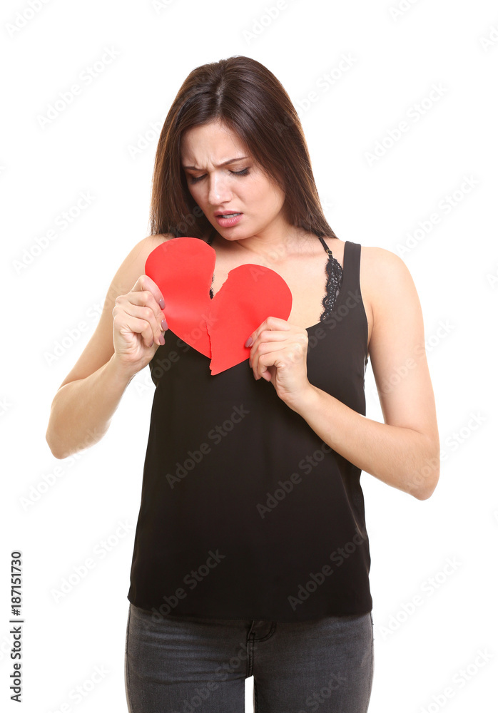 Young woman holding torn paper heart on white background Young woman holding torn paper heart on white background