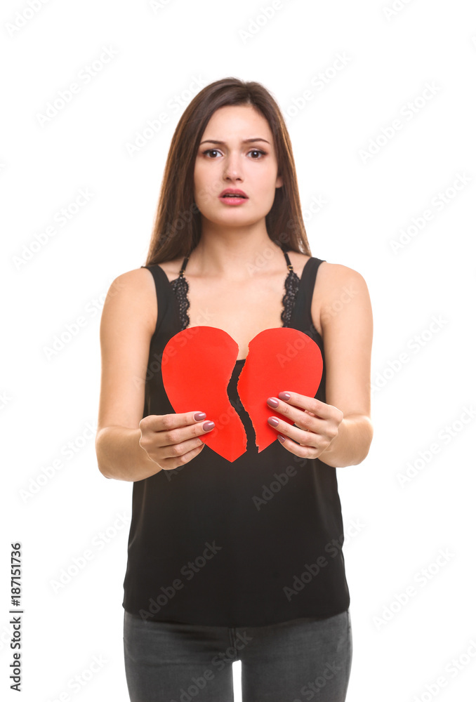 Young woman holding torn paper heart on white background Young woman holding torn paper heart on white background
