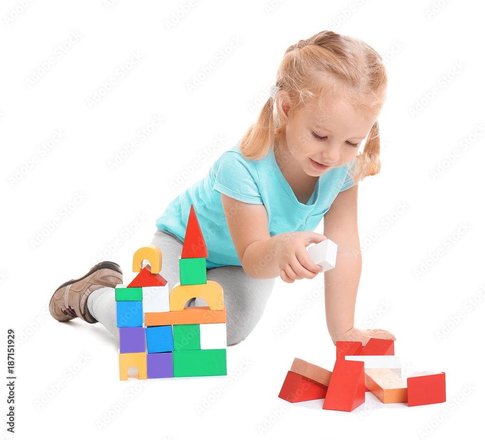 Cute little girl playing with building blocks on white background Cute little girl playing with building blocks on white background