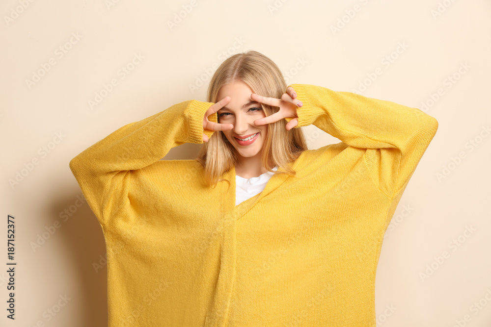 Young beautiful smiling woman on light background Young beautiful smiling woman on light background