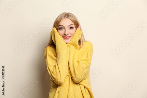 Young beautiful smiling woman on light background © Africa Studio