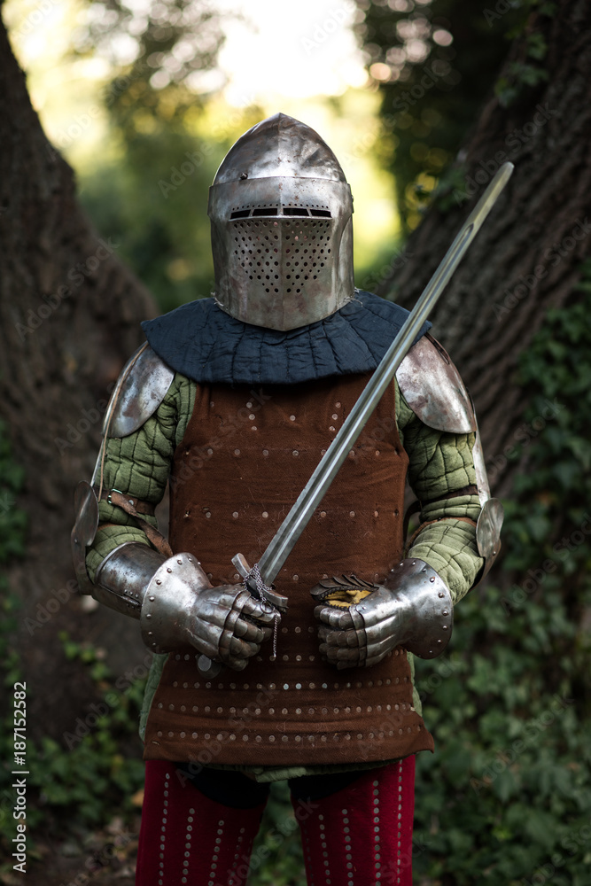 Knight with a sword in historical armor