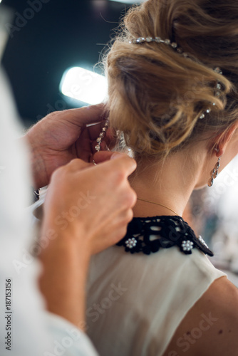bride get a professional hair style at beauty salon