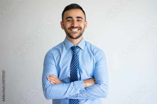 Smiling Successful Young Leader with Arms Crossed photo