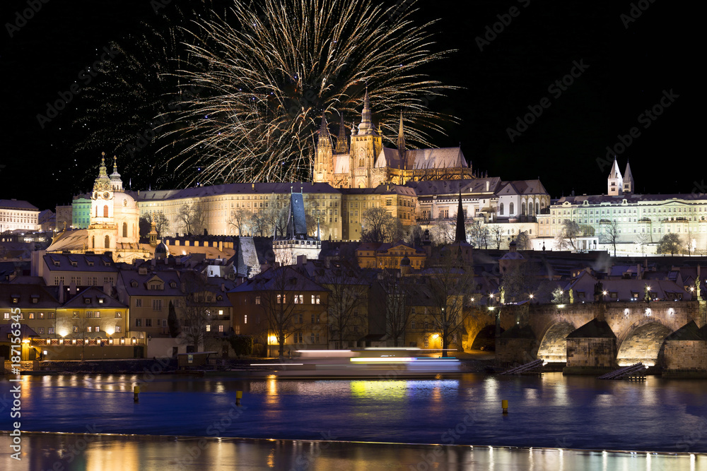 Fireworks above night colorful snowy Prague gothic Castle with Charles Bridge, Czech republic