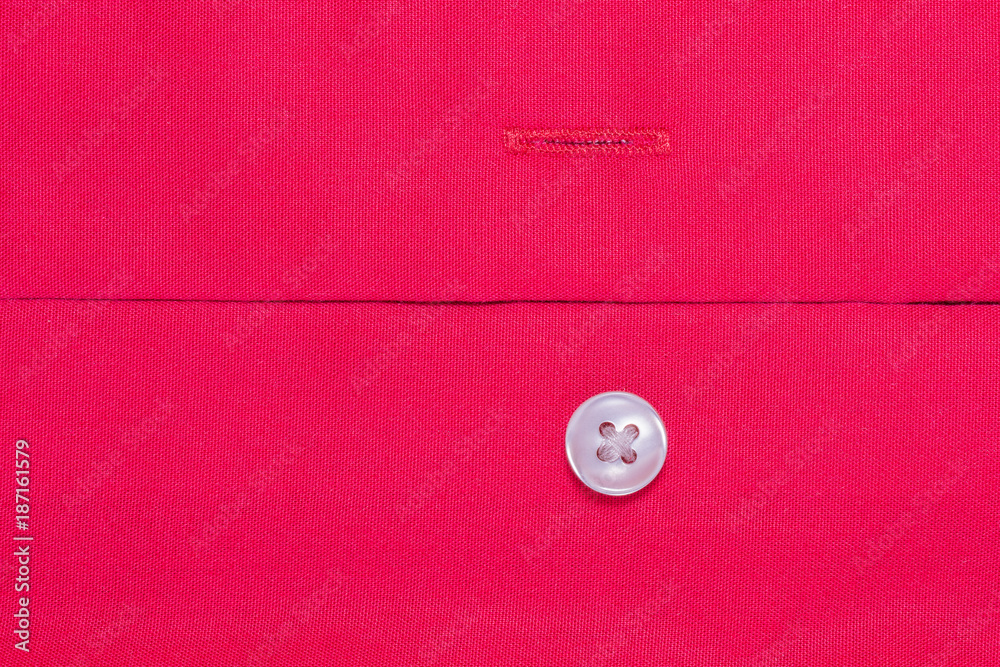 texture of a red cotton fiber surface forming a fabric, button is sewn to the fabric, abstract background texture of a red cotton fiber surface forming a fabric, button is sewn to the fabric, abstract background