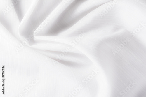 texture of white cotton fabric with arbitrary bends and wave, abstract background