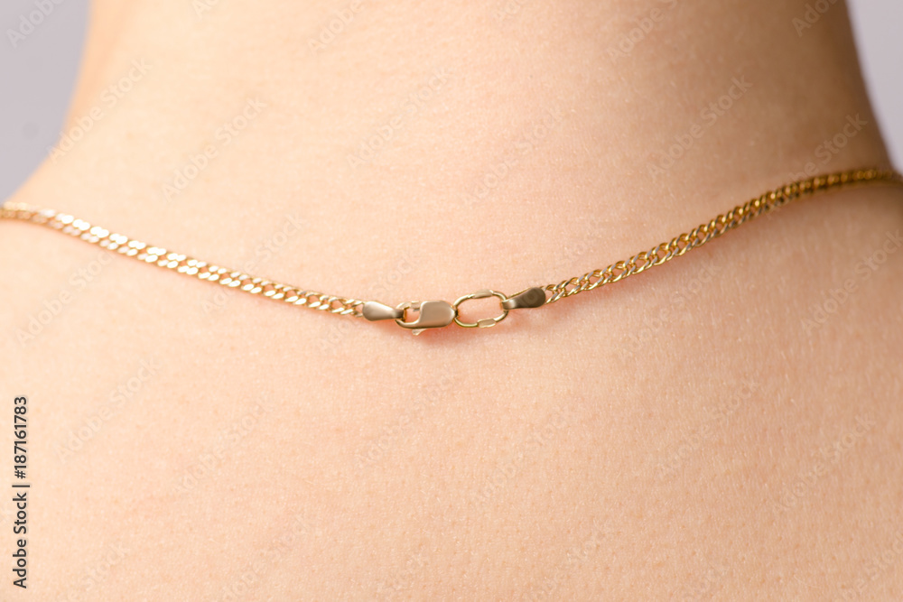 Clasp of a gold chain on the neck Clasp of a gold chain on the neck