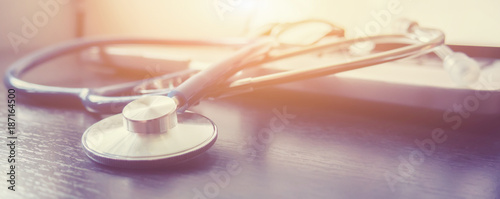 Stethoscope and laptop keyboard on desktop in hospital,relax time doctor,medical concept,selective focus,vintage color.morning light photo