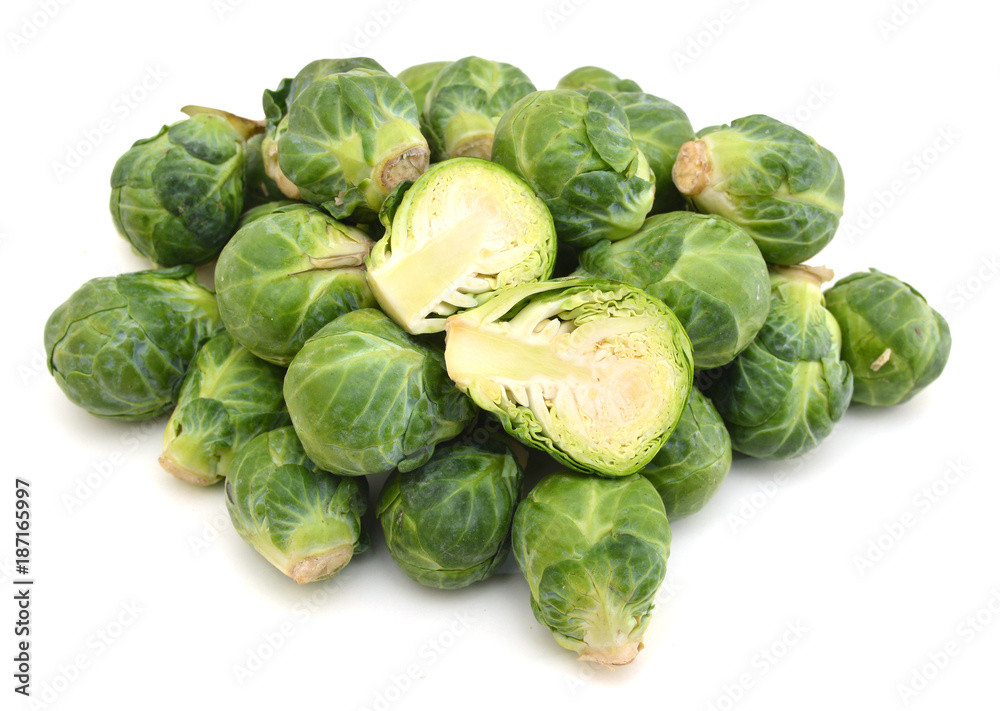 freshly brussel sprouts and some whole ones on a white background freshly brussel sprouts and some whole ones on a white background