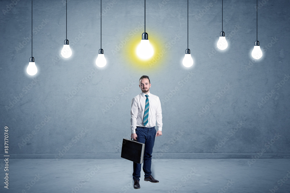 Fototapeta premium Businessman standing uninspired with bulbs above