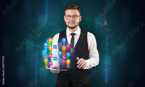 Man holding tablet with hologram app icons above