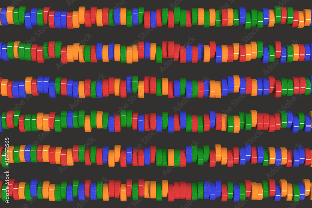Pattern of blue, red and green cylinder tablets on black background Pattern of blue, red and green cylinder tablets on black background