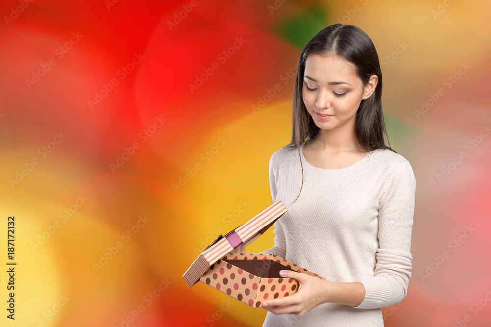 Beautiful smiling woman with long hair holding gift box Beautiful smiling woman with long hair holding gift box