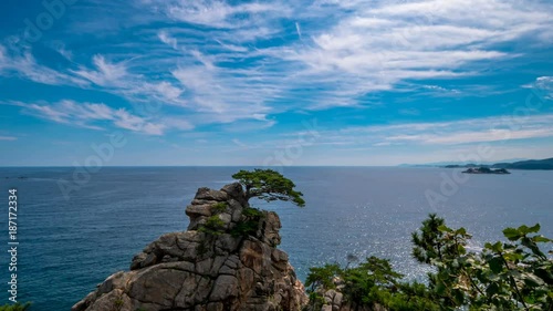 Time - lapse as the white clouds flow over the blue sea. photo