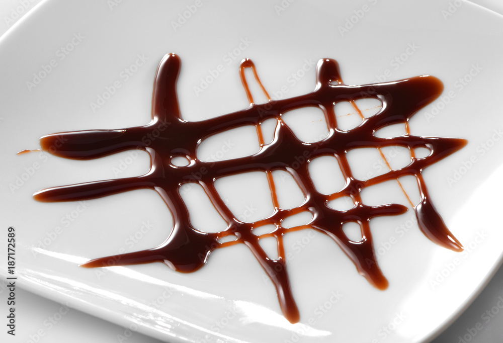 chocolate sauce decoration close-up on white plate Stock Photo | Adobe Stock