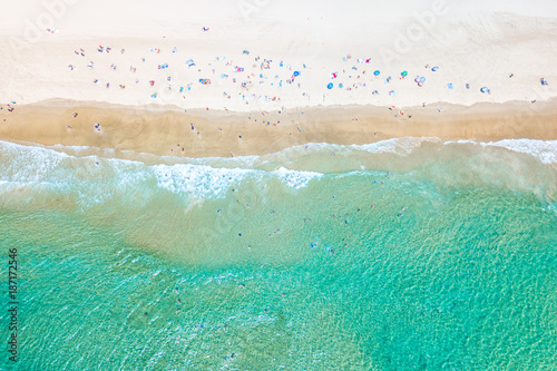 Photography People swimming at the beach in summer with blue water from an aerial perspectiv
