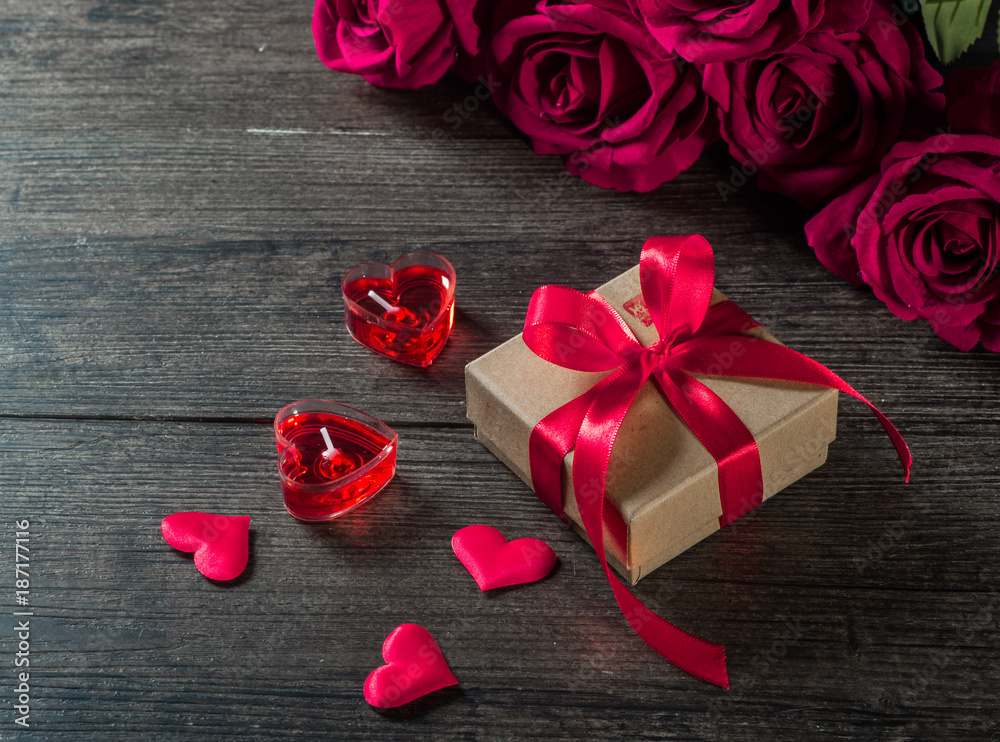 Valentine's day background, roses and gifts on a wooden board Valentine's day background, roses and gifts on a wooden board