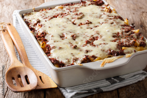 Million dollars pasta casserole with beef meat and cheese in a baking dish close-up. Horizontal