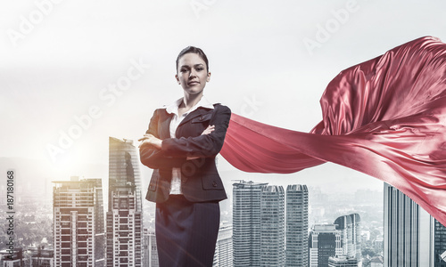 Concept of power and sucess with businesswoman superhero in big 