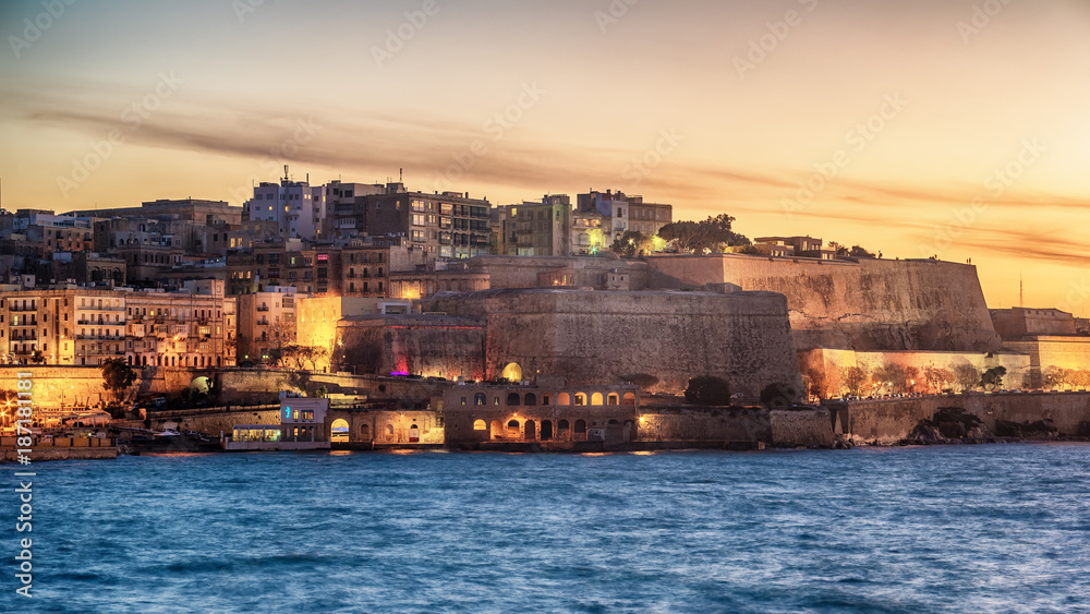 Malta: city walls of Valletta and Marsans Harbour at sunset Malta: city walls of Valletta and Marsans Harbour at sunset