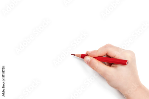 Child hand holding a red pencil and getting ready to draw, isolated on a white background