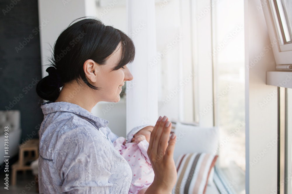 woman with her newborn baby meet her husband from work. family moments. the joy of meeting woman with her newborn baby meet her husband from work. family moments. the joy of meeting